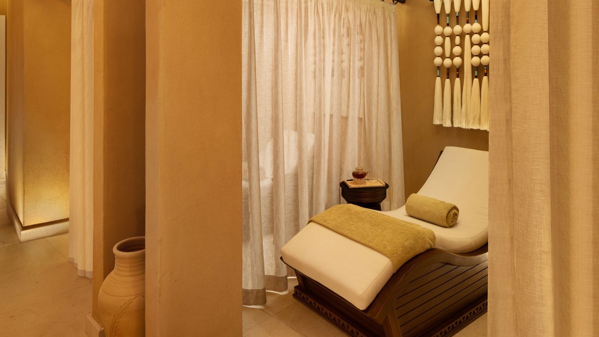 A relaxation alcove at Sidr Spa, Bab Samhan, behind linen curtains