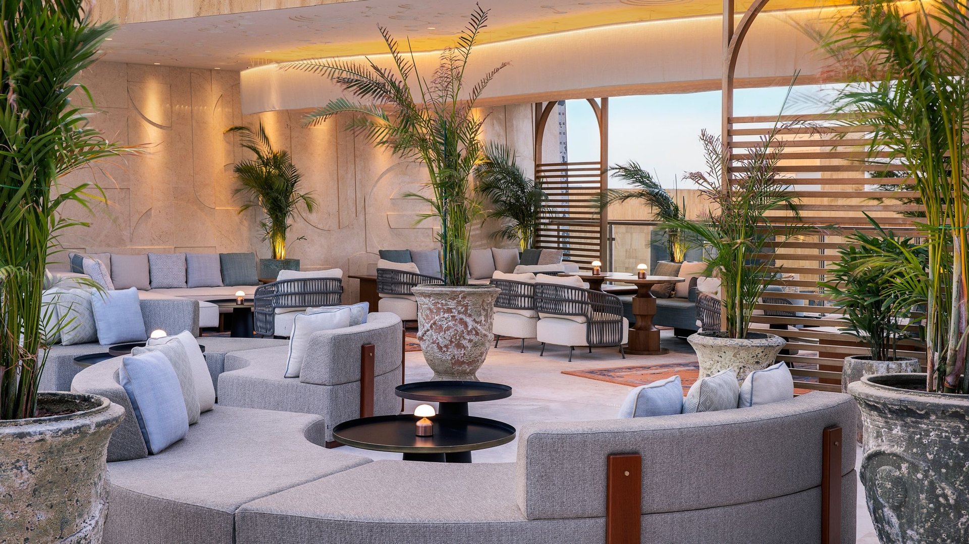 Stella Sky Lounge at The St. Regis Riyadh, curved sofas among potted palms