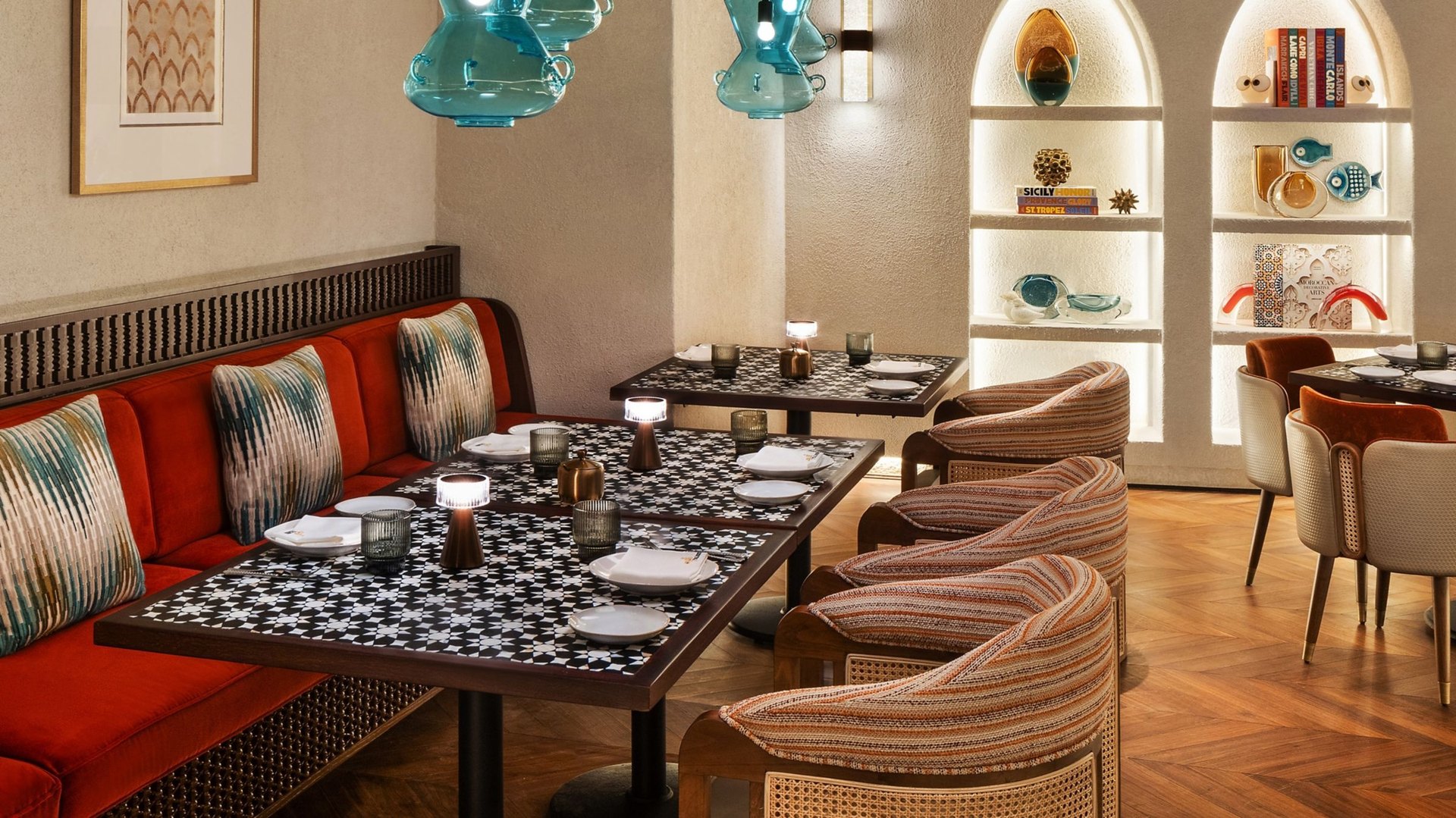 The dining room of Taleed by Michael Mina, star-tiled tables and blue glass lamps