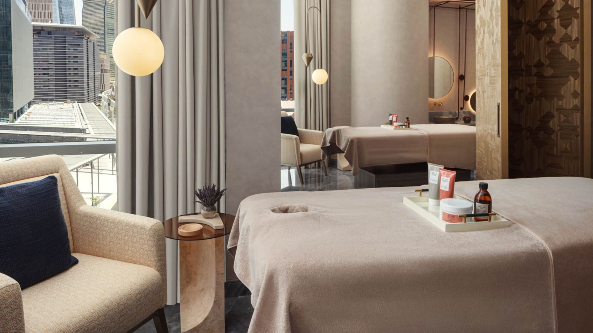 A treatment room at AWAY Spa, W Riyadh – KAFD, looking out over the towers of KAFD