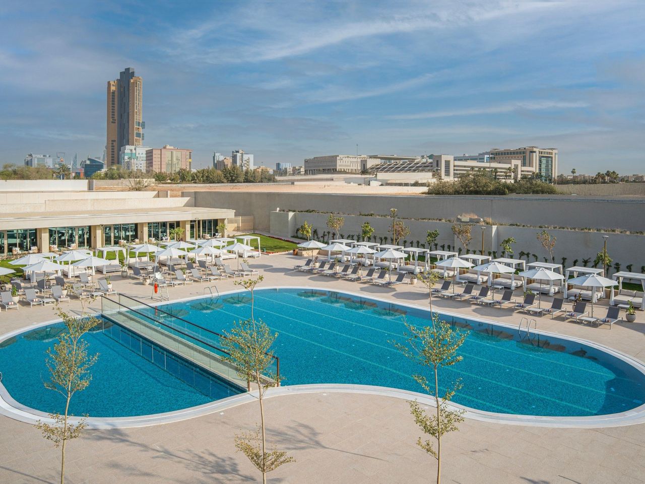 The outdoor pool of InterContinental Riyadh, ringed by loungers and cabanas